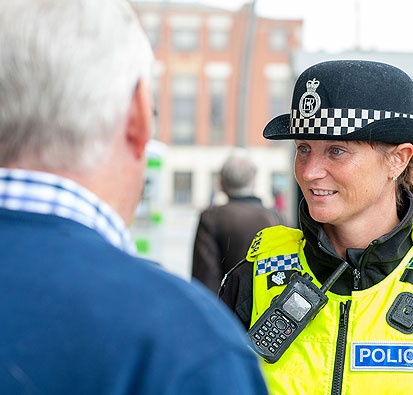 Image of Female Police Constable talking to people in the high street