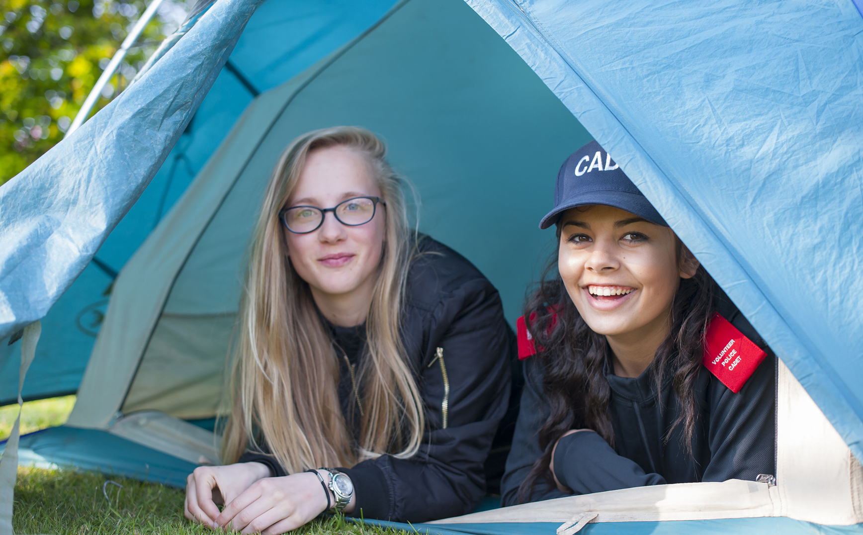 Northumbria police volunteer - two young female police cadets in tent with tent door open