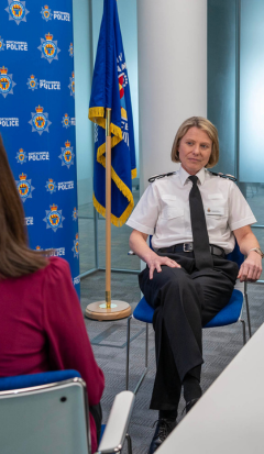 Chief Constable Vanessa being interviewed by a member of media with a Northumbria Police branded backdrop