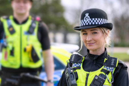 Female uniformed police officer facing camera wearing hat