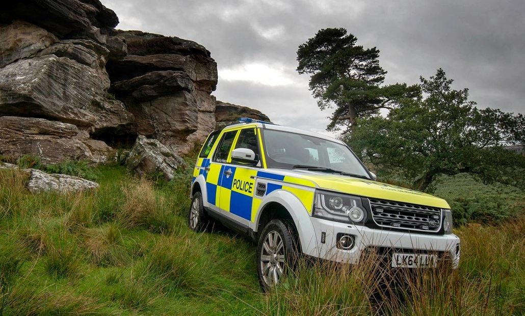 Northumbria police volunteer - rural crime marked police vehicle on a grass bank
